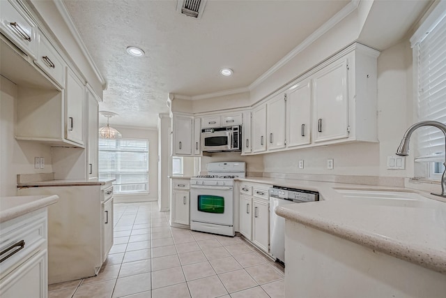 kitchen with stainless steel appliances, sink, white cabinets, crown molding, and light tile patterned flooring