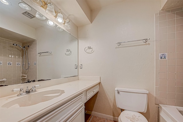 bathroom with vanity, tile patterned flooring, and toilet