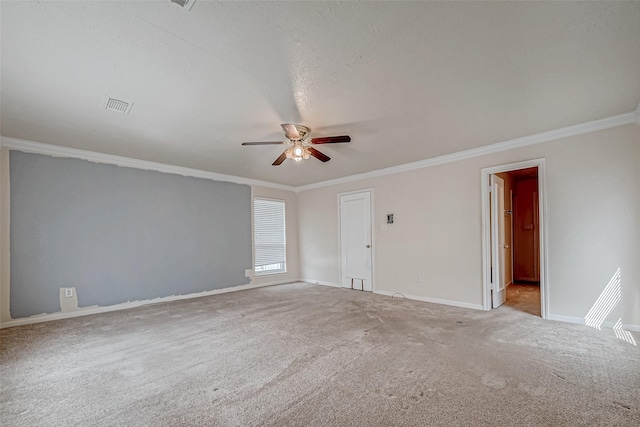 spare room with ceiling fan, ornamental molding, and light carpet