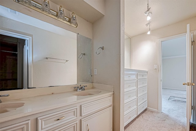 bathroom featuring rail lighting and vanity