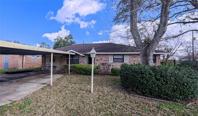 ranch-style house with a front yard and a carport