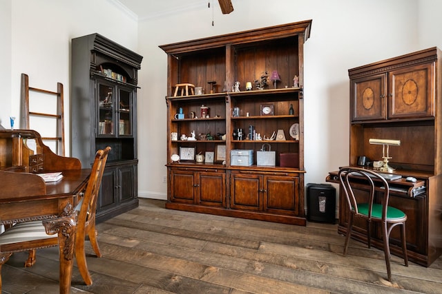 interior space with dark wood-style flooring, a ceiling fan, and crown molding