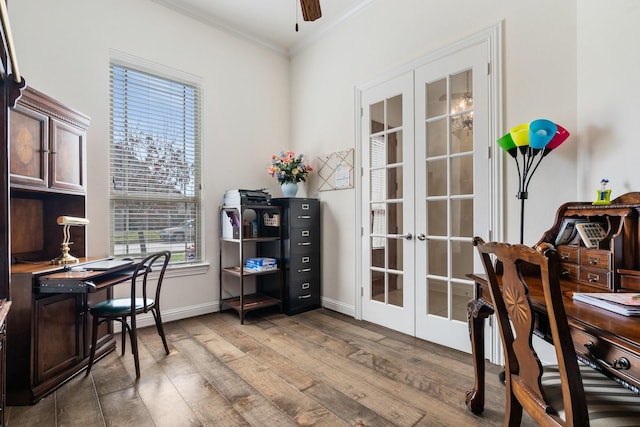 office space featuring baseboards, ornamental molding, a ceiling fan, wood-type flooring, and french doors