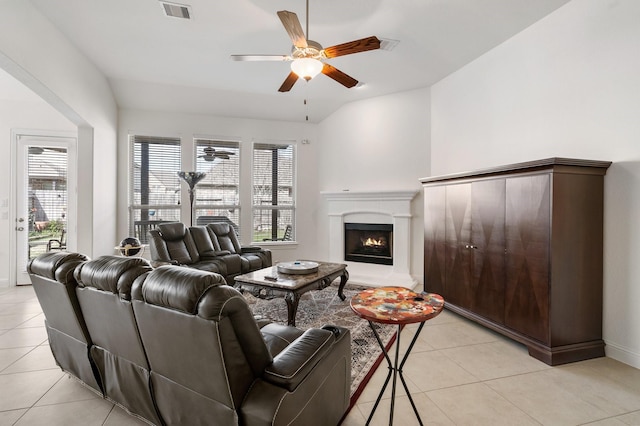 living room featuring plenty of natural light, visible vents, light tile patterned flooring, and ceiling fan