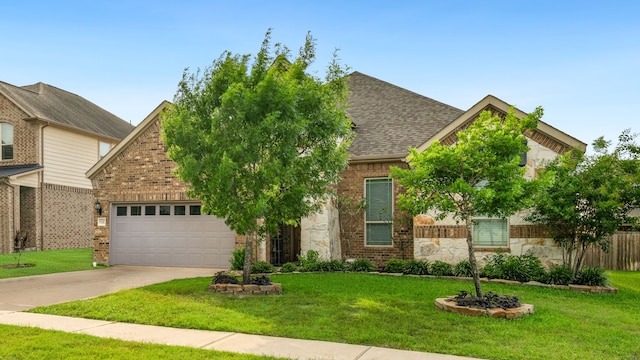 9518 Brannok Ln, Tomball, TX 77375 - view of front of home featuring driveway, stone siding, an attached garage, and brick siding