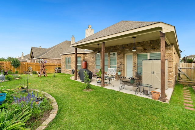 9518 Brannok Ln, Tomball, TX 77375 - back of house featuring a ceiling fan, brick siding, a patio area, a chimney, and roof with shingles