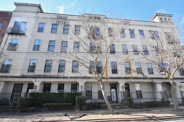 view of property with central AC and fence