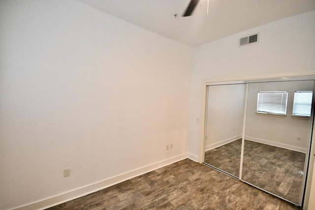 unfurnished bedroom with visible vents, baseboards, a ceiling fan, wood finished floors, and a closet