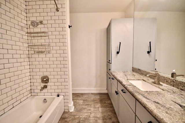 bathroom with shower / washtub combination, vanity, and baseboards