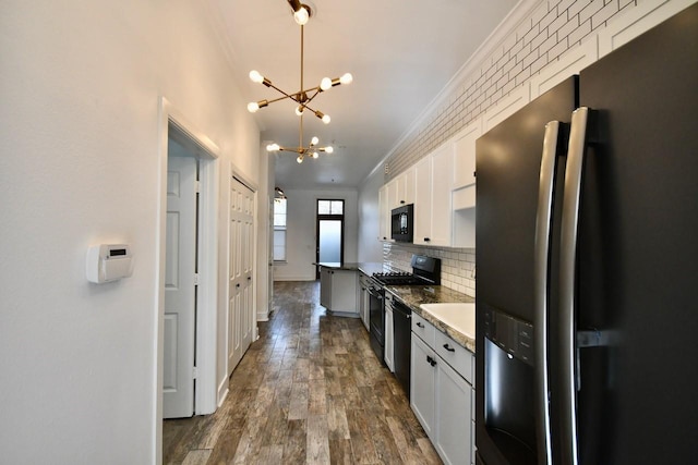 kitchen with a chandelier, dark wood-style flooring, decorative backsplash, black appliances, and crown molding