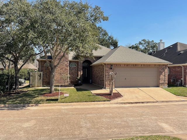 view of front of property featuring a front lawn and a garage