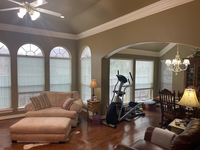 living room with ceiling fan with notable chandelier, dark wood-type flooring, crown molding, and lofted ceiling