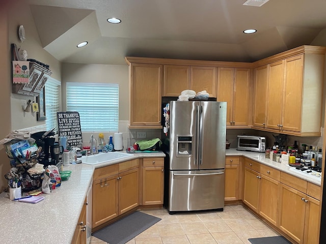 kitchen featuring white gas cooktop, stainless steel fridge with ice dispenser, sink, tasteful backsplash, and light tile patterned flooring