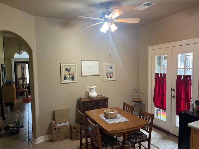 tiled dining area with french doors and ceiling fan