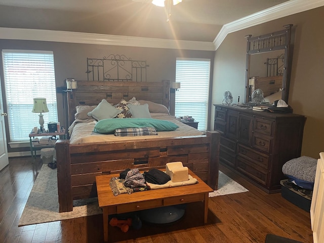 bedroom with dark hardwood / wood-style flooring and crown molding