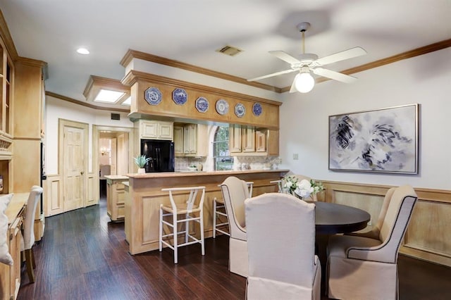 dining space with crown molding, ceiling fan, and dark hardwood / wood-style floors