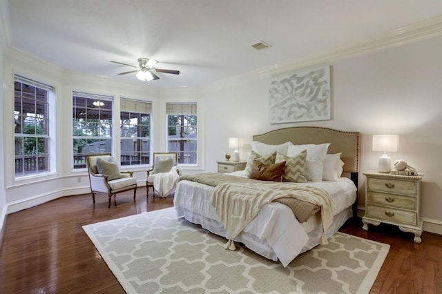 bedroom with crown molding, ceiling fan, and dark hardwood / wood-style floors