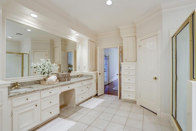 bathroom with vanity, ornamental molding, tile patterned floors, and walk in shower