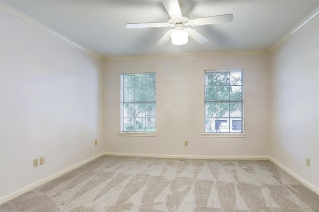 spare room featuring crown molding, light colored carpet, and a healthy amount of sunlight