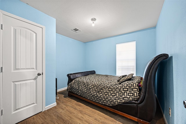 bedroom with hardwood / wood-style flooring