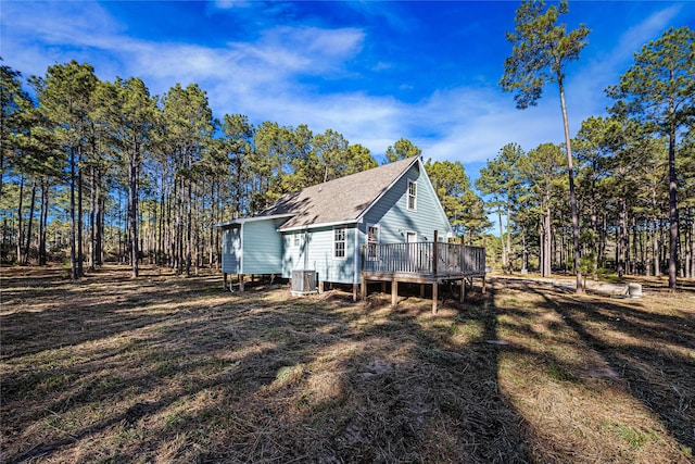 view of property exterior with a wooden deck and central AC unit