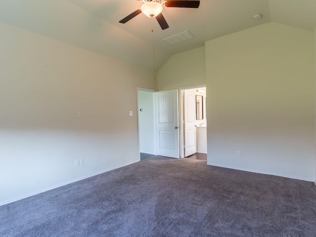 unfurnished room with dark colored carpet, vaulted ceiling, and ceiling fan