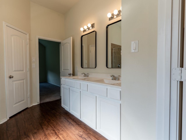 bathroom with hardwood / wood-style flooring, vanity, and walk in shower