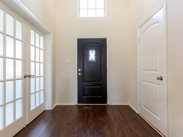 foyer entrance with plenty of natural light, dark hardwood / wood-style flooring, and french doors