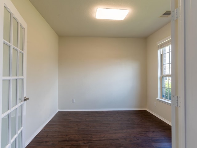 unfurnished room with dark hardwood / wood-style floors