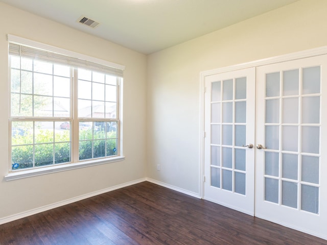 unfurnished room featuring dark hardwood / wood-style flooring and french doors