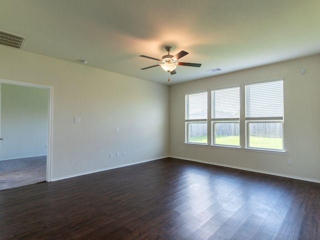 unfurnished room with dark hardwood / wood-style floors and ceiling fan