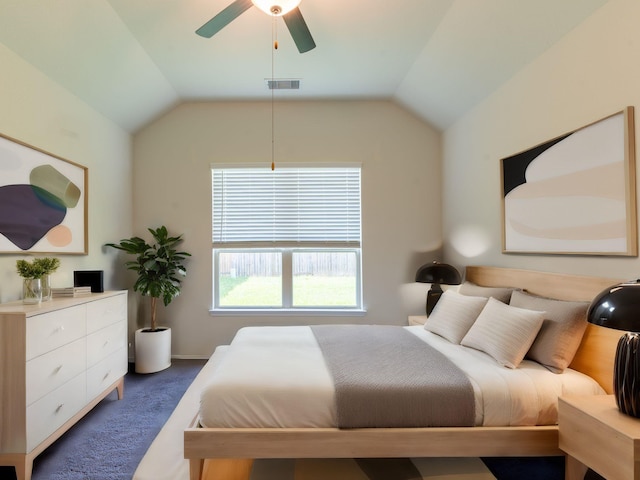 carpeted bedroom with ceiling fan and vaulted ceiling