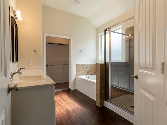 bathroom with hardwood / wood-style flooring, vanity, lofted ceiling, and separate shower and tub