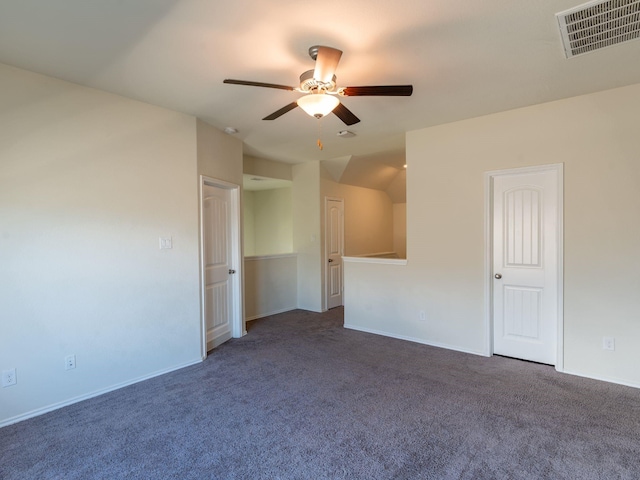 unfurnished room with ceiling fan and dark colored carpet