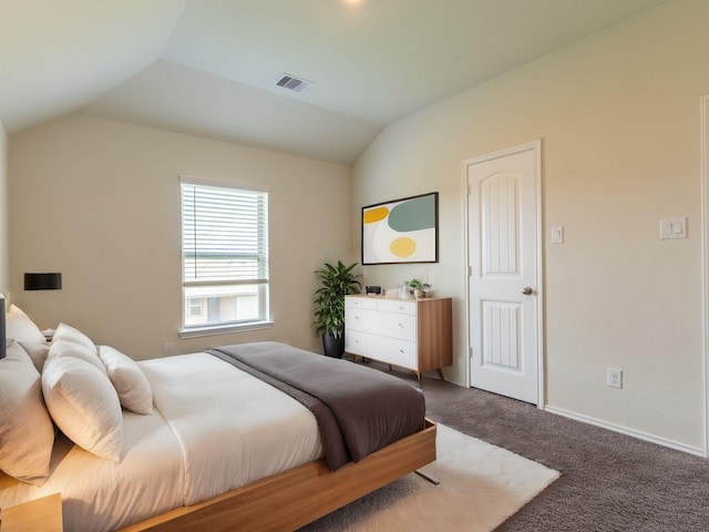 carpeted bedroom with lofted ceiling