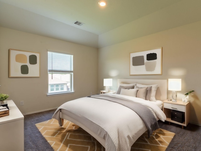 bedroom featuring dark colored carpet