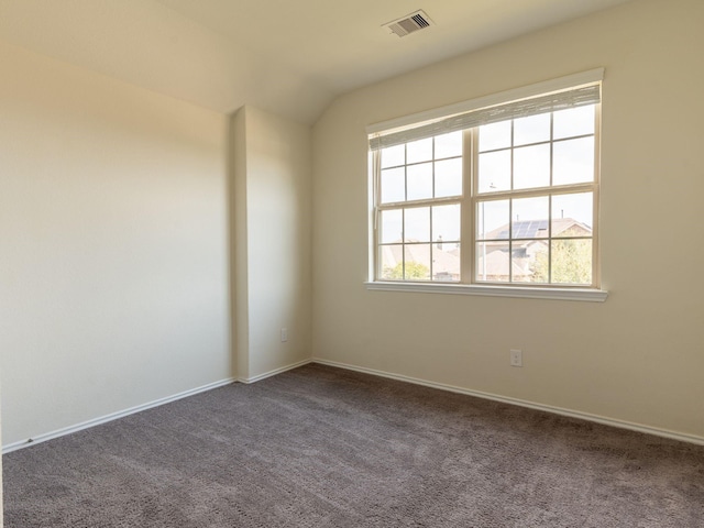 empty room with lofted ceiling and carpet floors