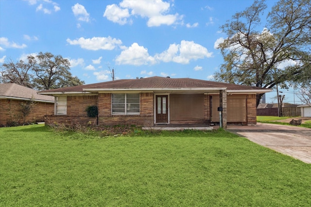 ranch-style house featuring an attached garage, driveway, brick siding, and a front yard