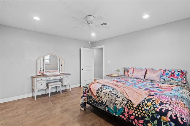 bedroom with ceiling fan and light hardwood / wood-style floors