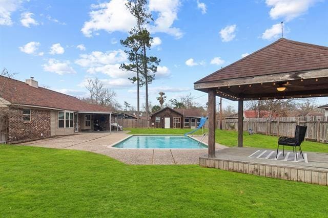 view of pool featuring a gazebo, a lawn, an outdoor structure, and a patio area