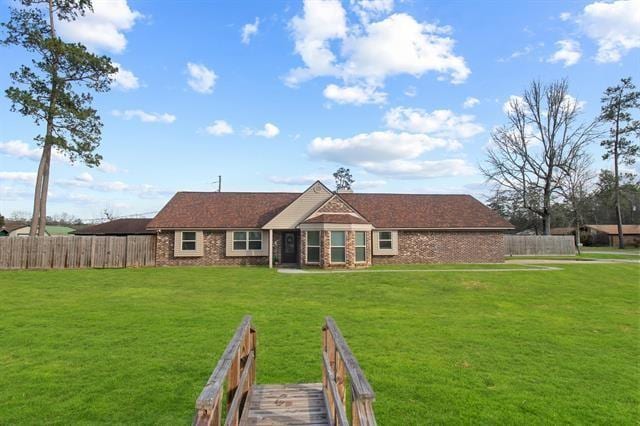 rear view of house featuring a lawn