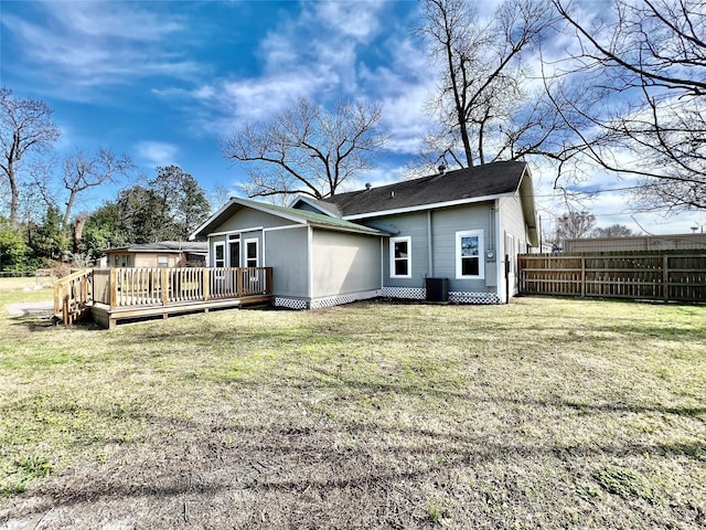 back of property featuring central AC unit, a deck, and a lawn