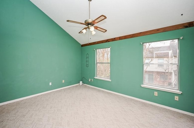 carpeted empty room featuring baseboards, lofted ceiling, and a ceiling fan