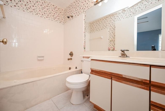 full bath featuring tile patterned floors, toilet, vanity, and tub / shower combination