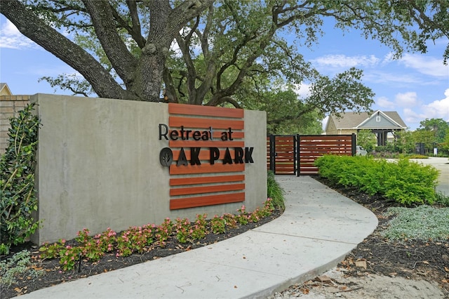 community sign featuring fence and a gate