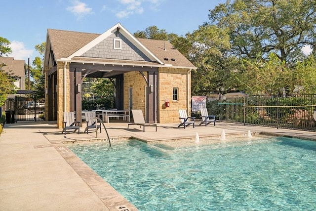 community pool featuring a patio area, fence, and a gazebo