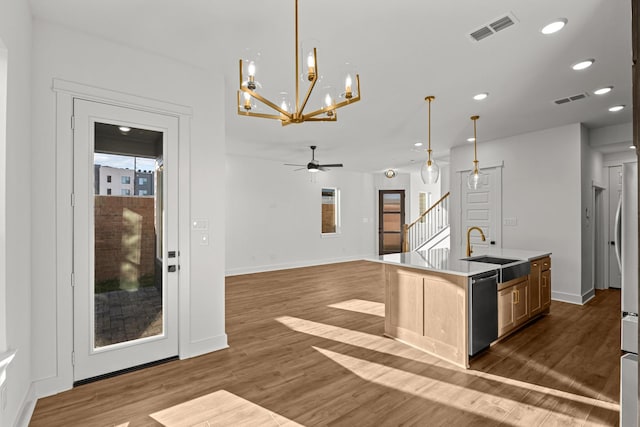 kitchen featuring a sink, dishwasher, a chandelier, dark wood-style flooring, and recessed lighting