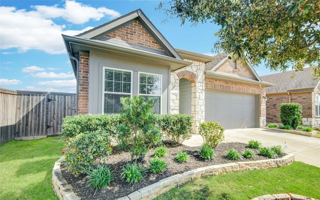 view of front of home with a front yard and a garage