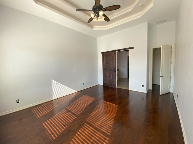 11707 W Grand Pond Dr, Montgomery, TX 77356 - unfurnished bedroom featuring dark wood-style flooring, a tray ceiling, baseboards, and visible vents