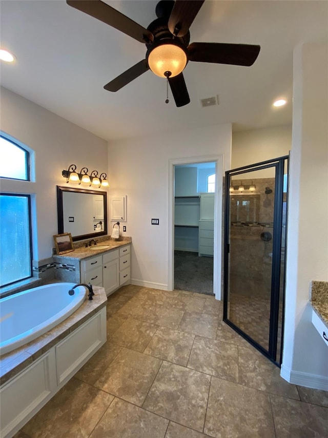 11707 W Grand Pond Dr, Montgomery, TX 77356 - full bath featuring a bath, vanity, a ceiling fan, visible vents, and a stall shower